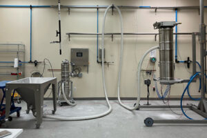 Volkmann pneumatic vacuum conveying test laboratory with bag dump station