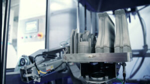 3D printed metal part in Volkmann automated depowdering station for additive manufacturing