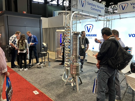 Volkmann booth at Pack Expo with pneumatic vacuum conveyor